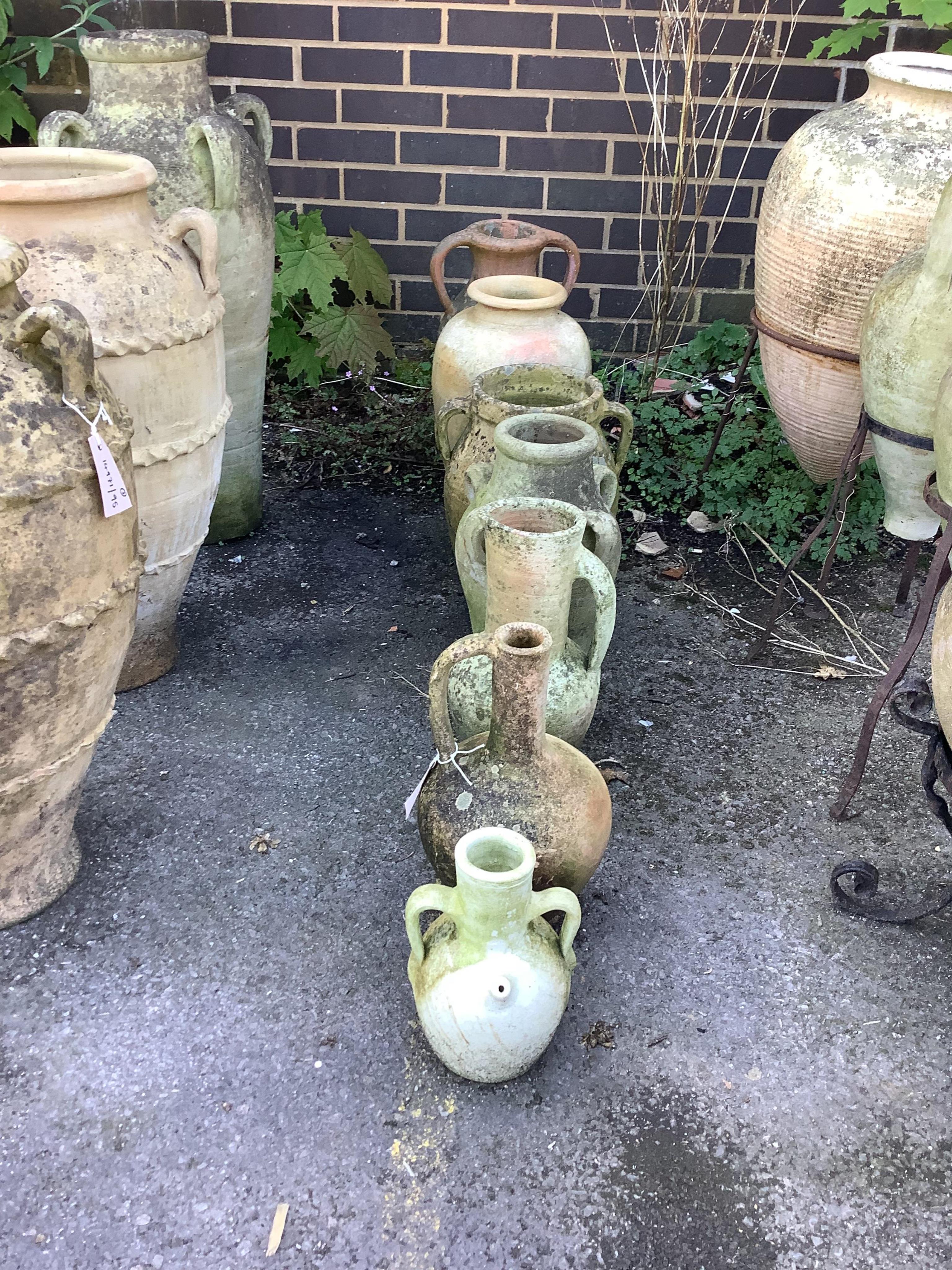Seven terracotta and earthenware jars and urns, largest height 48cm. Condition - fair